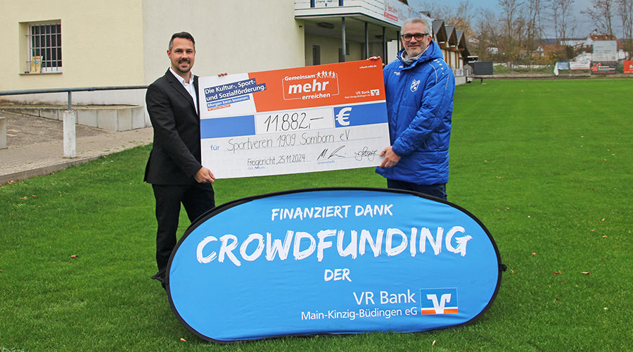 Das Bild zeigt die Spendenübergabe in Höhe von 11.882 Euro an den SV Somborn. Vertreter der VR Bank überreichen einen Scheck zur Unterstützung des Crowdfunding-Projekts.