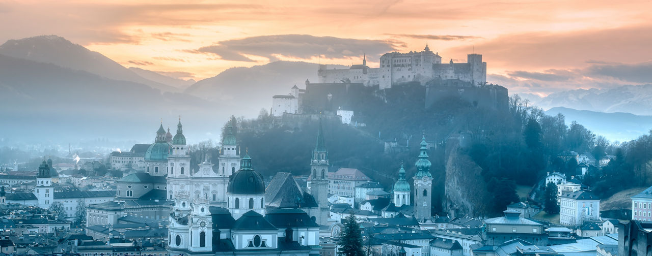 Panoramic view of Salzburg and Kapuzinerberg hill at winter morning sunrise, Austria