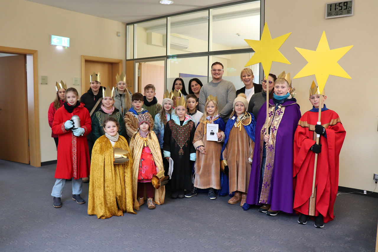 Kinder Sternsinger Ginsheim stehen in der Bank mit unseren Mitarbeitern