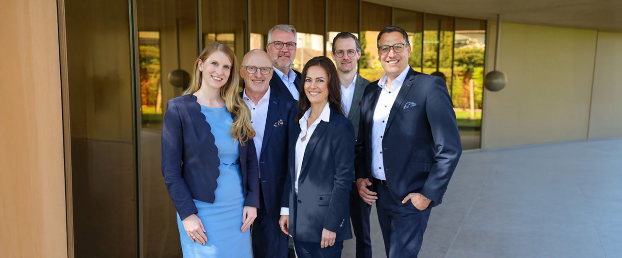 Der Vorstand der Werte-Stiftung-Münsterland steht vor dem Gebäude der Werte-Bank-Münsterland
