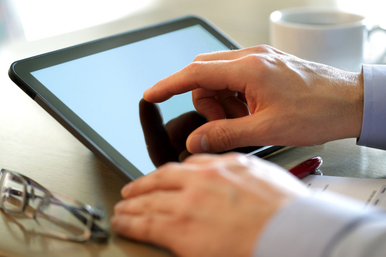 Eine Person bedient ein Tablet mit dem Finger