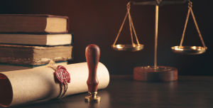 Bücher, eine Kaufmannswaage und eine Schriftrolle mit Wachssiegel