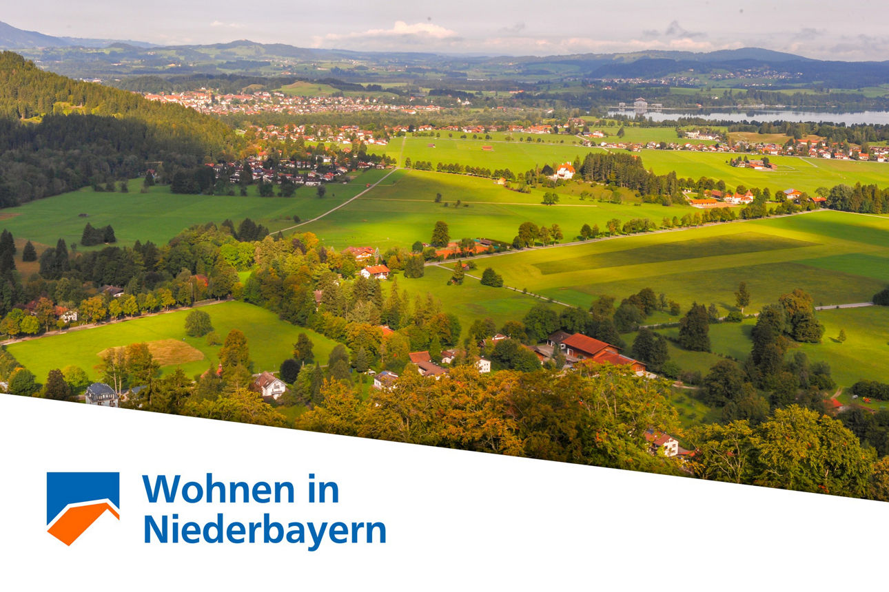 Abbildung einer grünen Landschaft mit Text "Wohnen in Niederbayern"