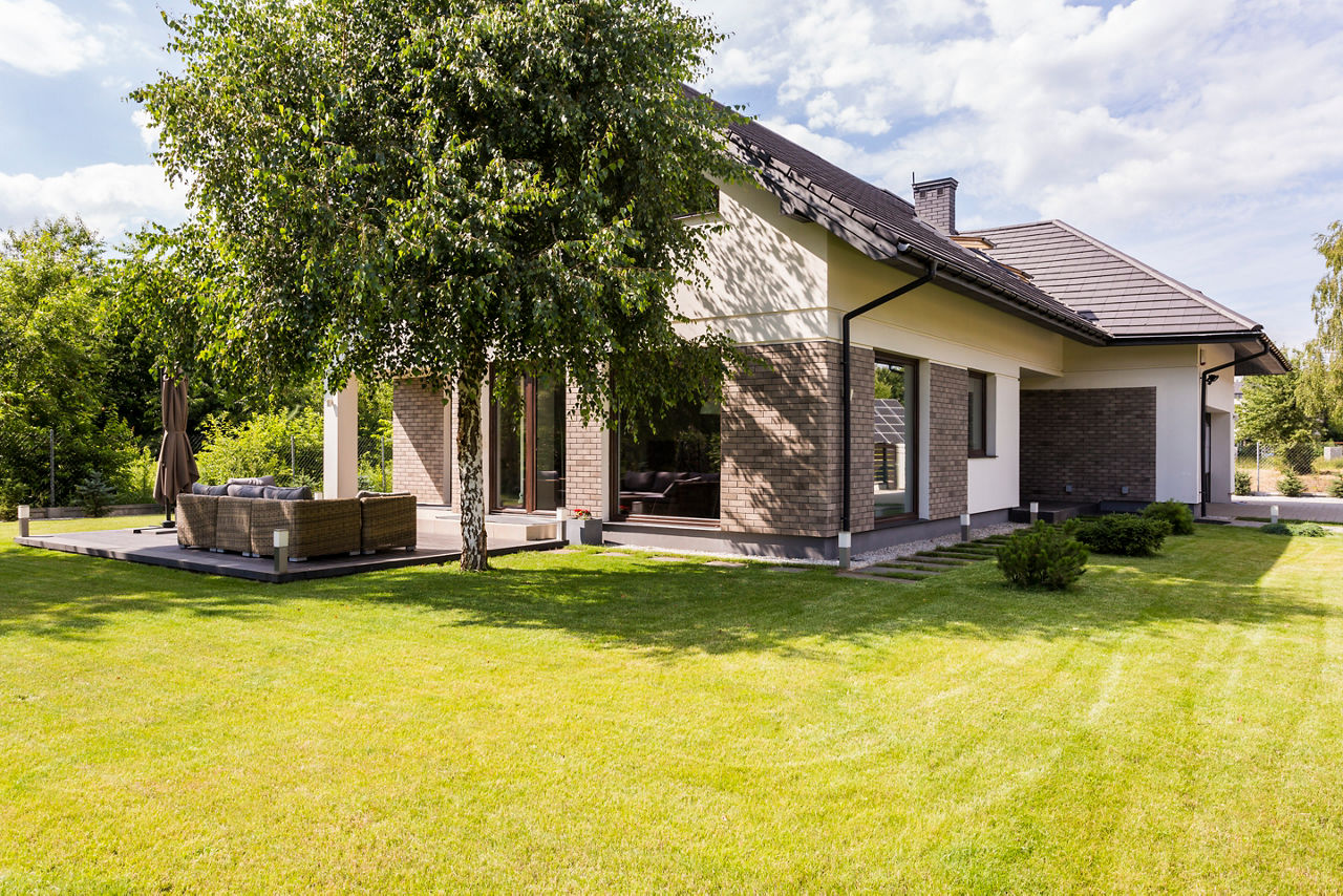 Shot of a big detached house surrounded by its garden