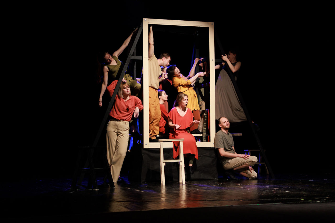 Actors and actresses perform a modern performance on the stage of the theater.