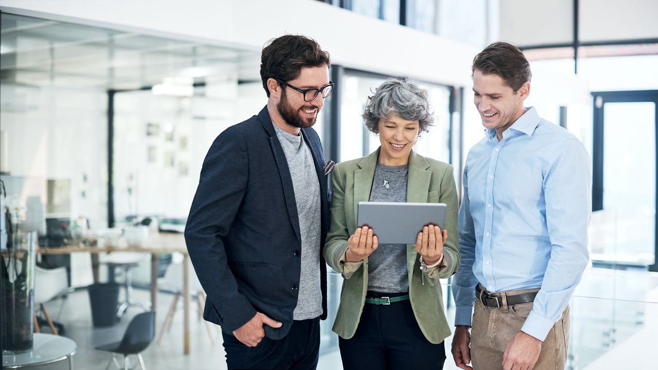 Shot of a group of businesspeople using a digital tablet together in an office