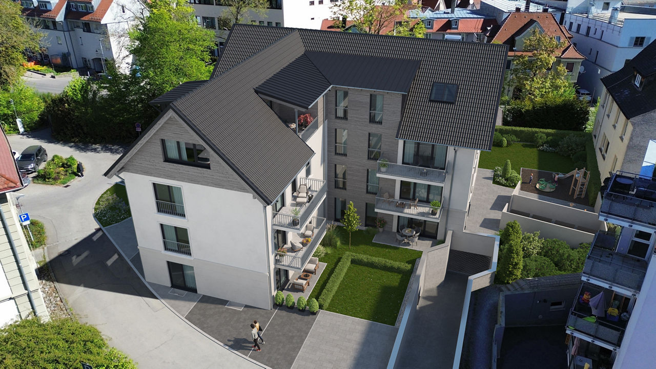 Luftaufnahme eines modernen Mehrfamilienhauses mit Eigentumswohnungen, Balkonen, Gartenflächen und gepflegter Außenanlage in 