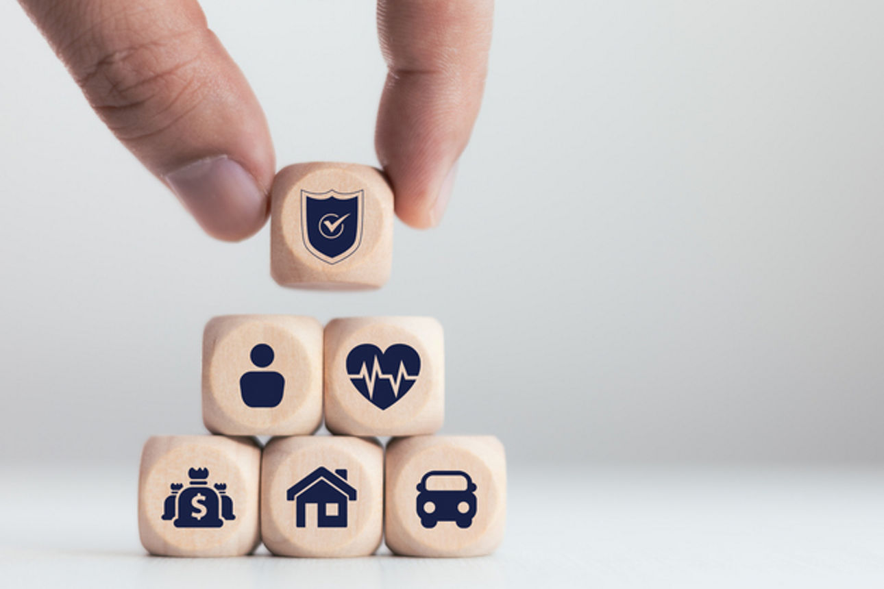 Insurance technology concept, hand laying wooden blocks, various insurance icons