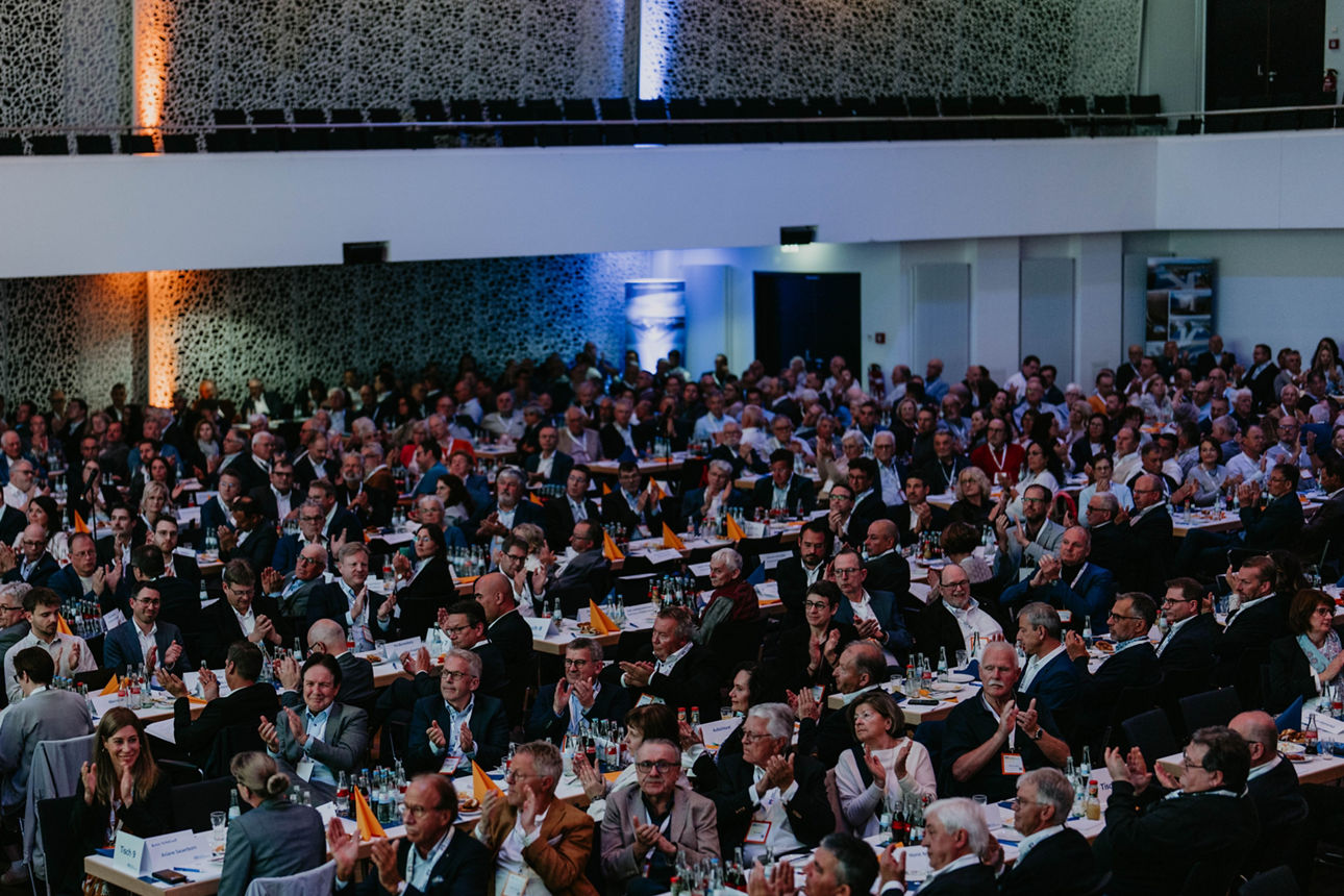 Das Bild zeigt Menschen an Tischen bei der Vertreterversammlung