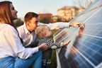 Einen junge Familie steht  fasziniert vor Solar-Modulen