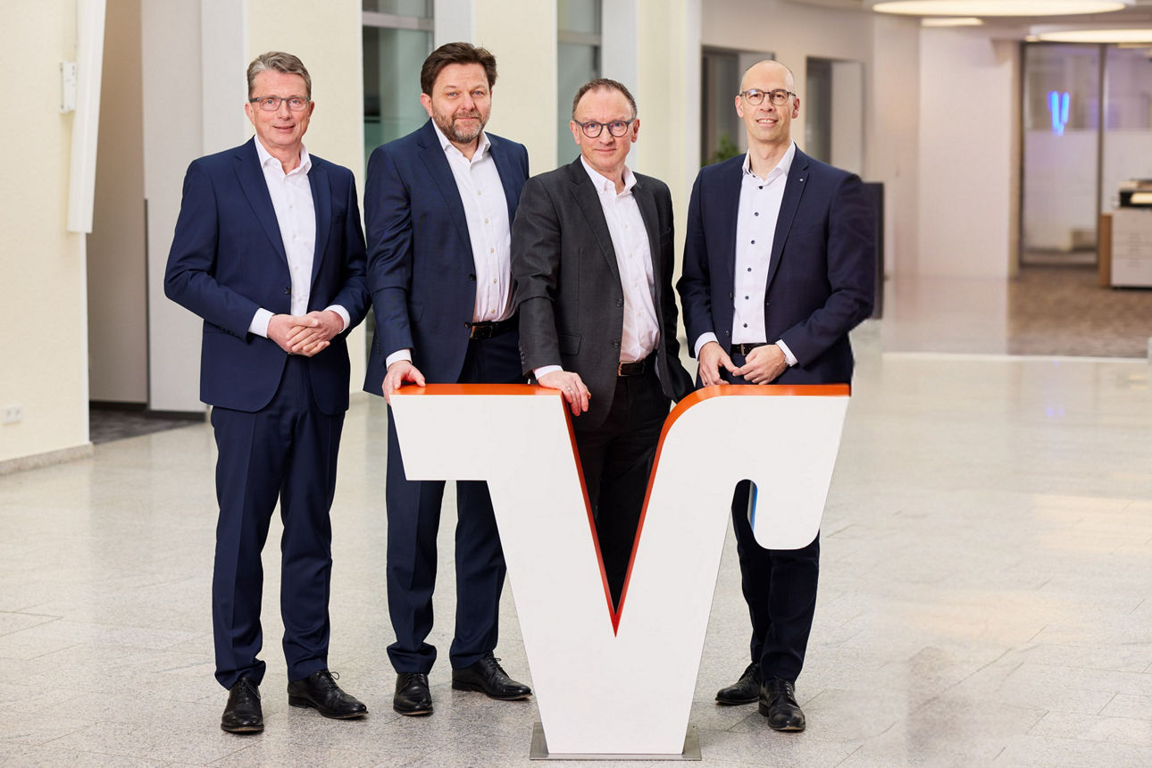 Die vier Vorstände der Volksbank in Ostwestfalen stehen hinter einem großen Volksbank "V".