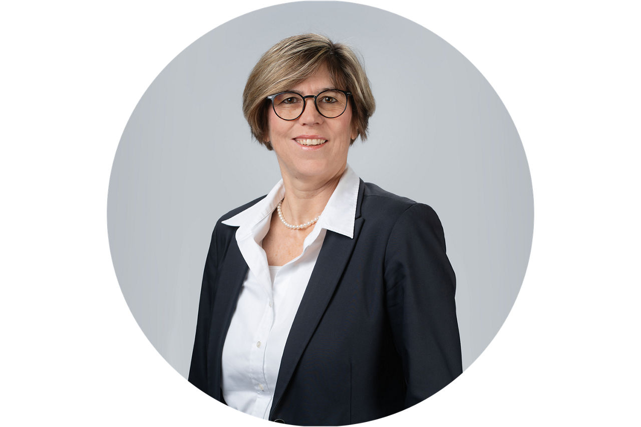 Porträt von Petra Kalbhenn, Vorstand der VR Bank Main-Kinzig-Buedingen eG, vor grauem Hintergrund.