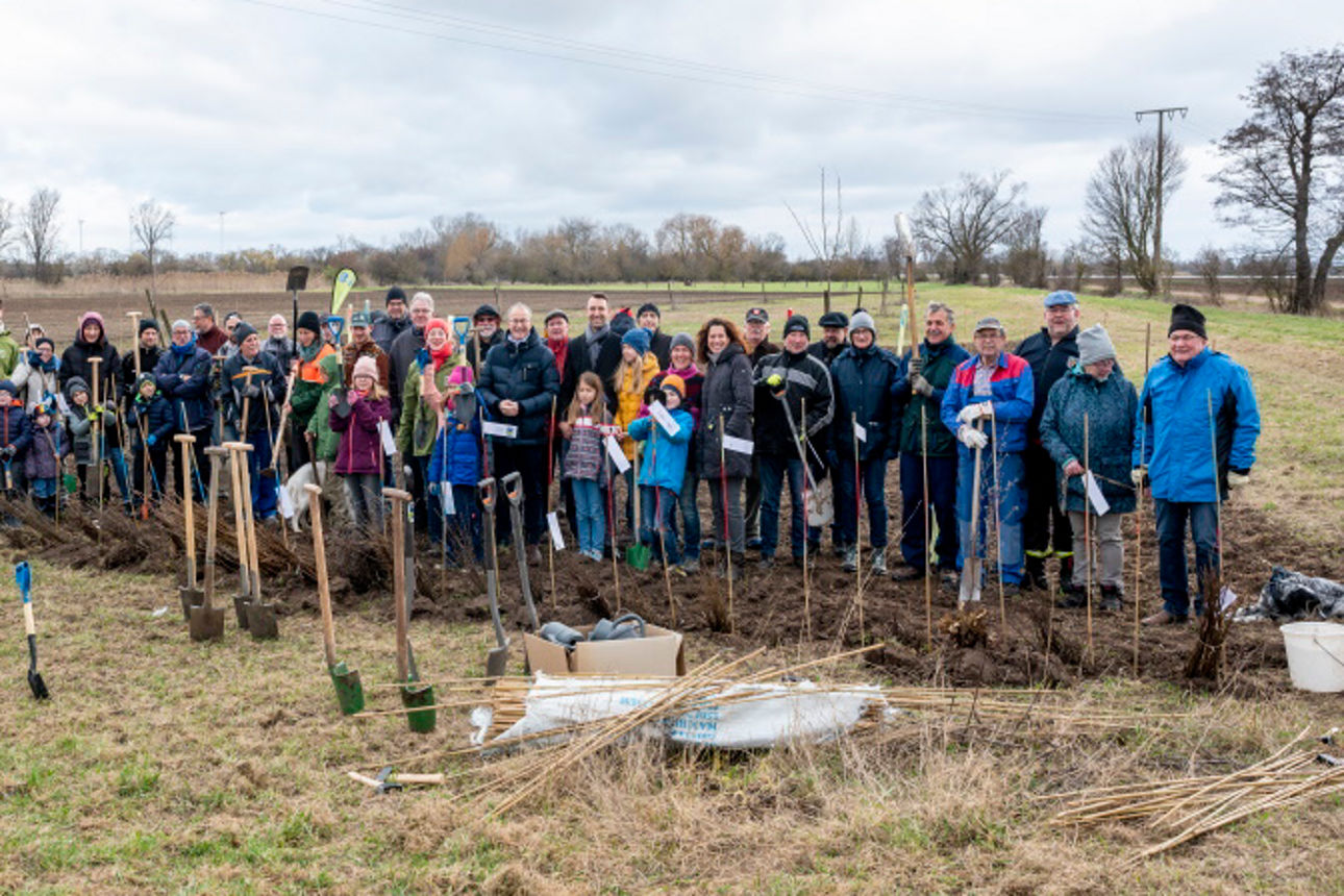 Gruppe von Menschen steht auf einer Wiese