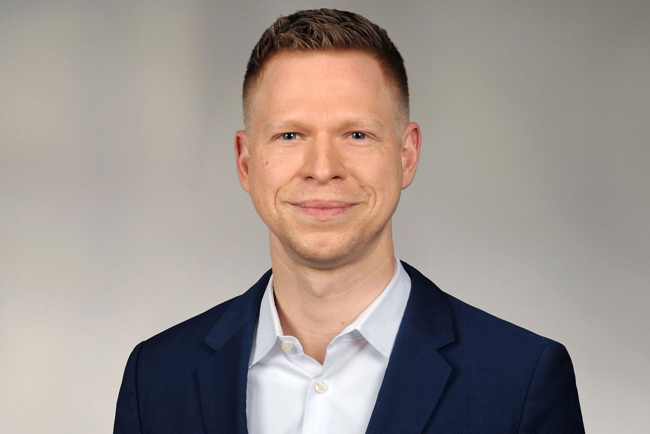 Dominik Weber hat kurze blonde Haare und trägt einen Anzug