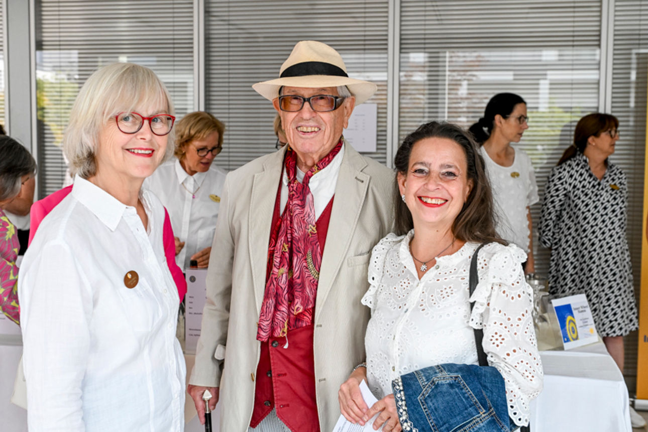 Drei Personen lachen in die Kamera