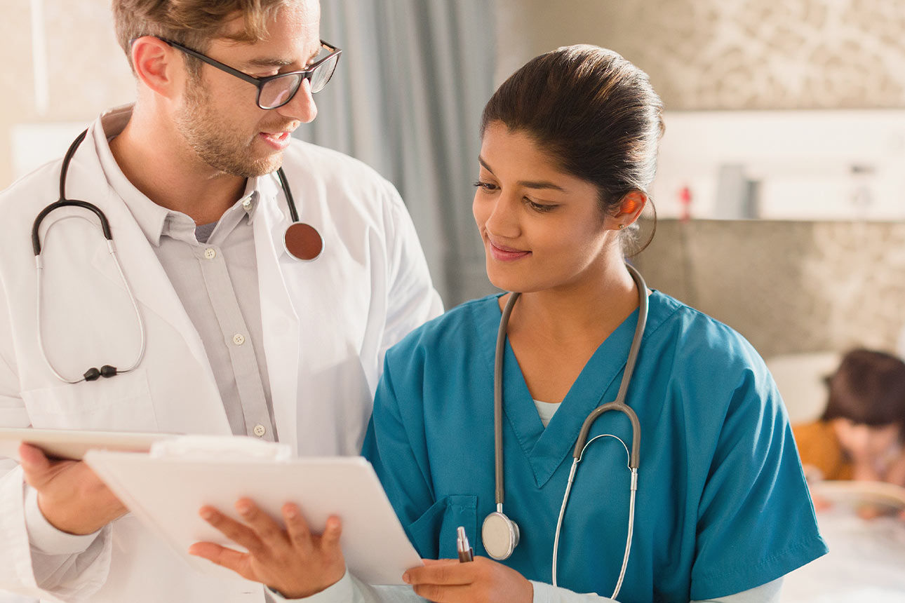 Ein Arzt und eine Krankenschwester schauen auf eine Krankenakte