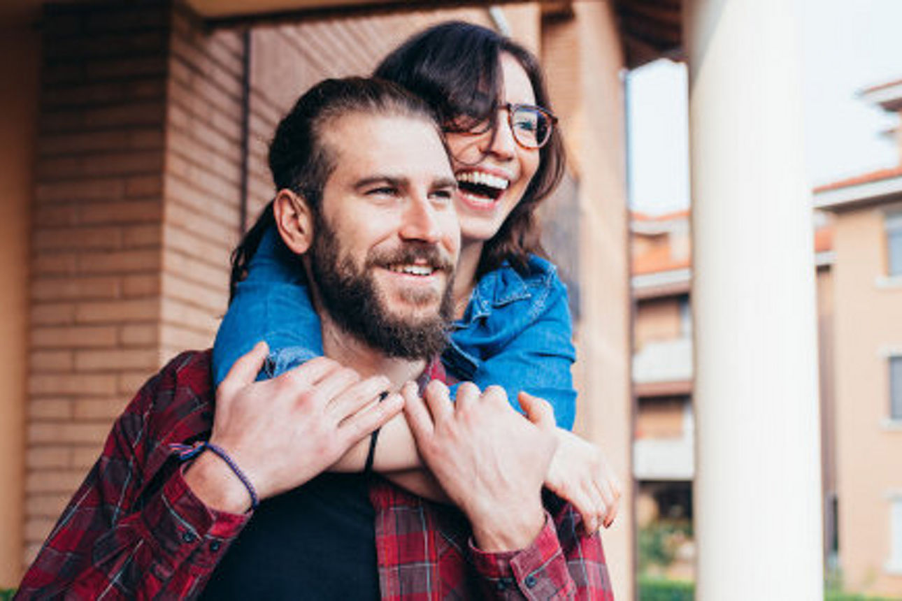 Young beautiful happy couple at home hugging - love, tenderness, romance concept