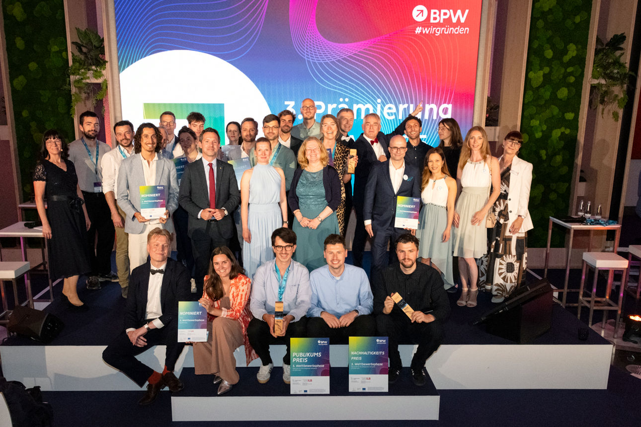 Gruppenfoto von Preisträgern und Nominierten auf der Bühne einer Preisverleihung.