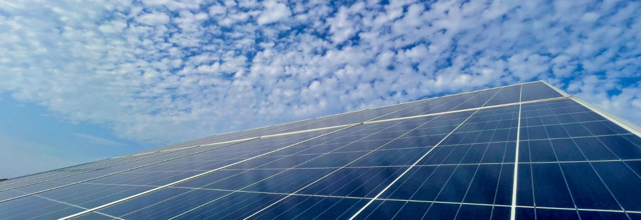 Photovoltaikanlage auf dem Dach mit Himmel und Wolken im Hintergrund