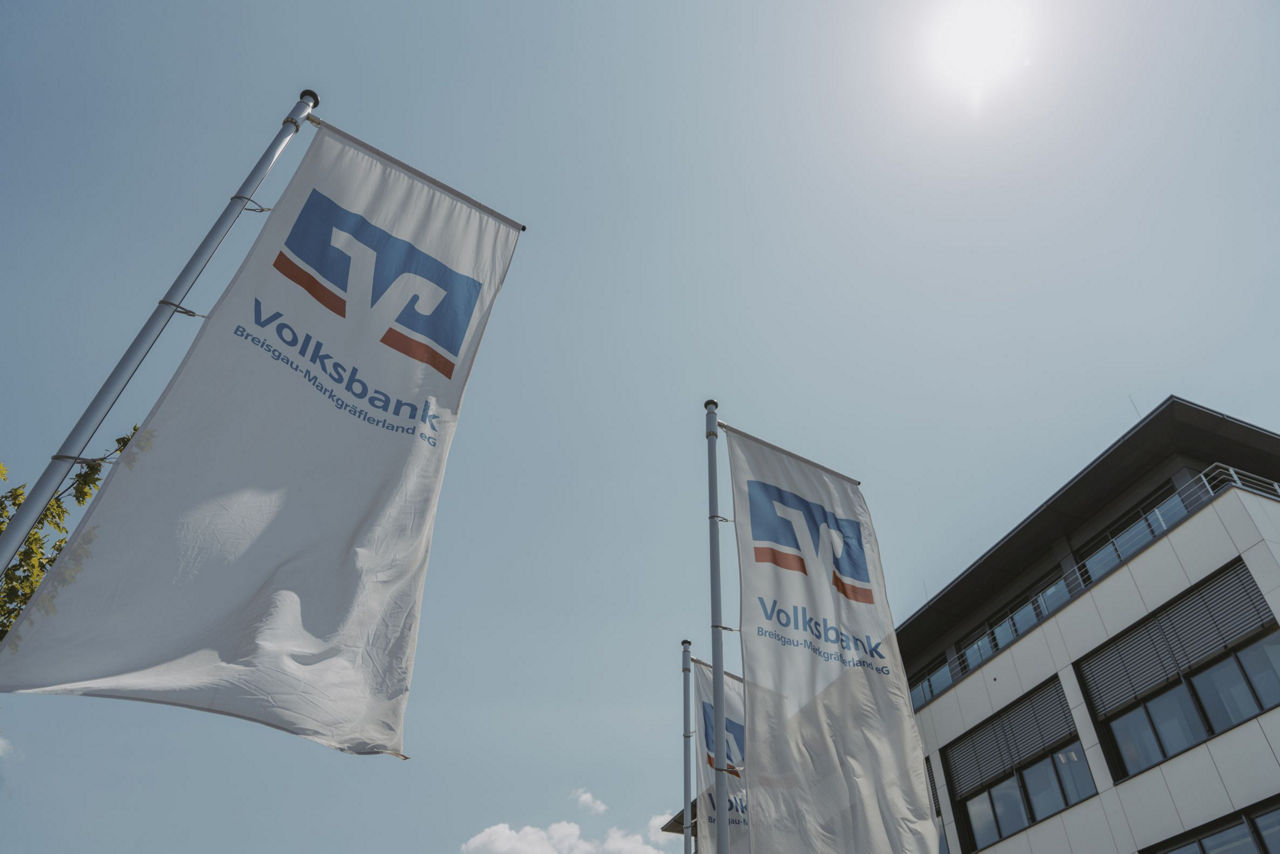 Wehende Fahnen vor dem WerteHaus der Volksbank Breisgau-Markgräflerland eG.