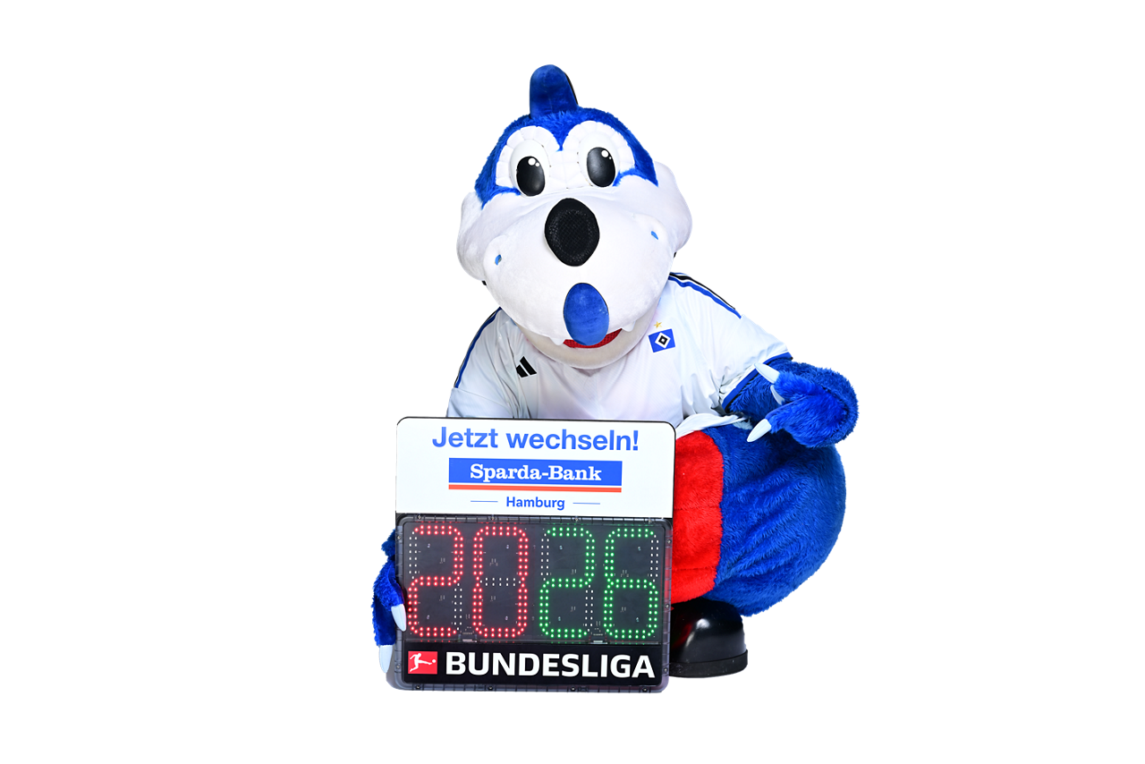 HSV Dino Hermann mit Sparda-Bank Wechsel-Banner in der Hand