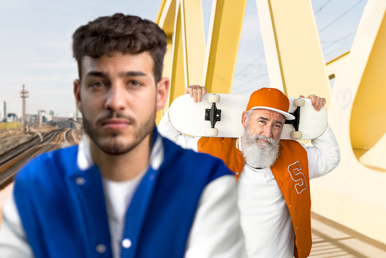 Ein junger Mann im Vordergrund, im Hintergrund ein älterer Mann, der ein Skateboard trägt