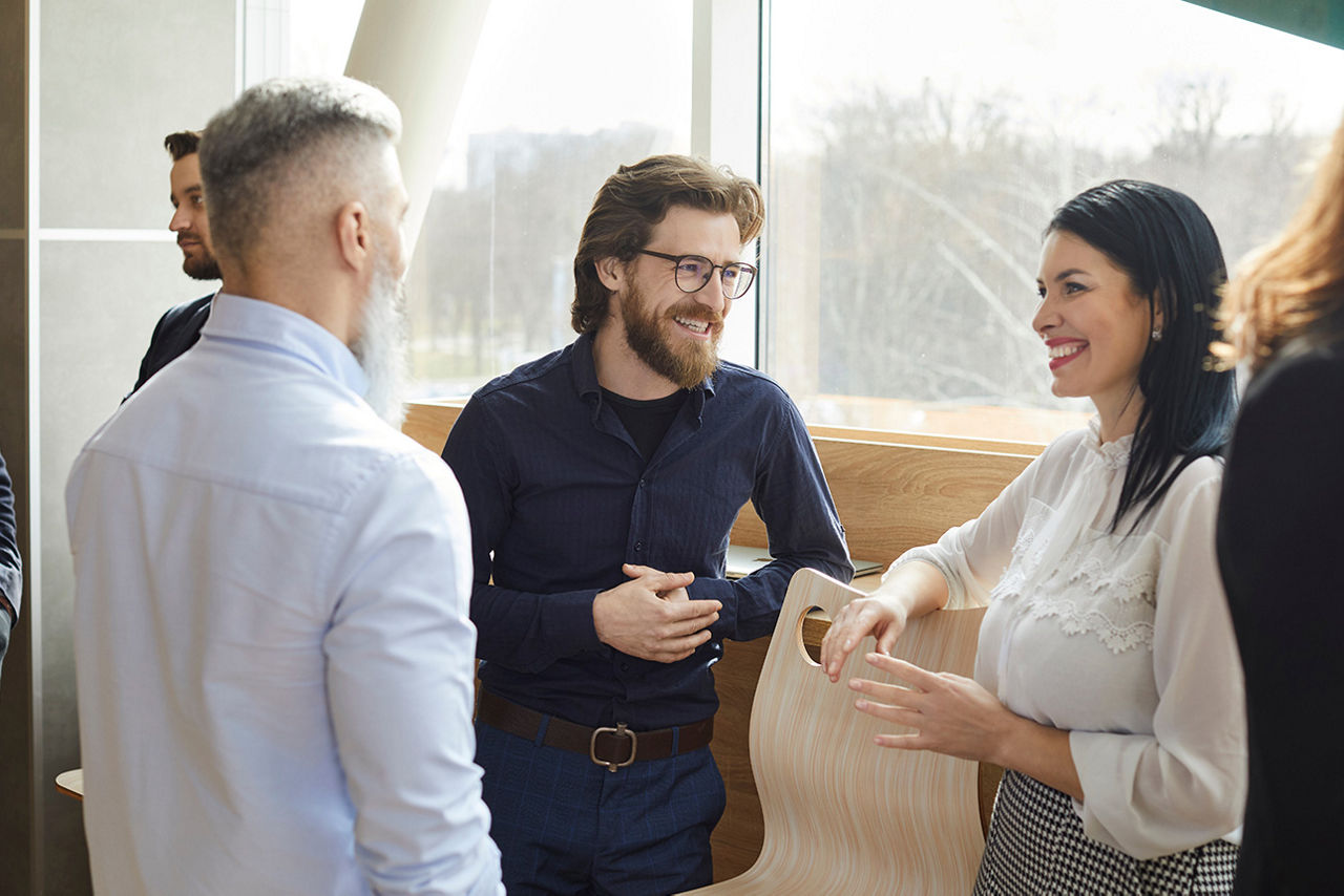 Business - Menschen stehen in einem Meeting zusammen. 