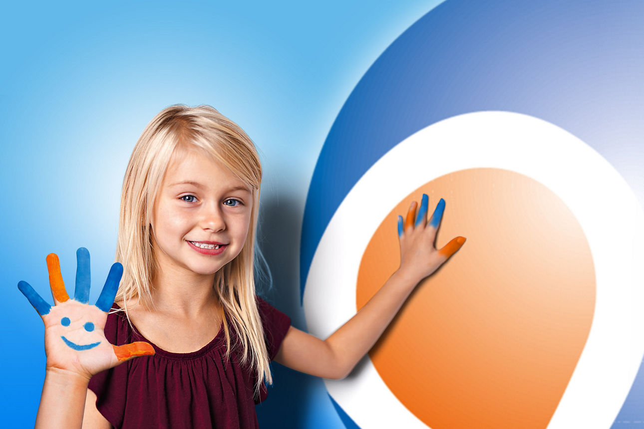 Mädchen im Grundschulalter mit geöffneter Hand, auf die mit Fingerfarben ein lachendes Gesicht gemalt ist