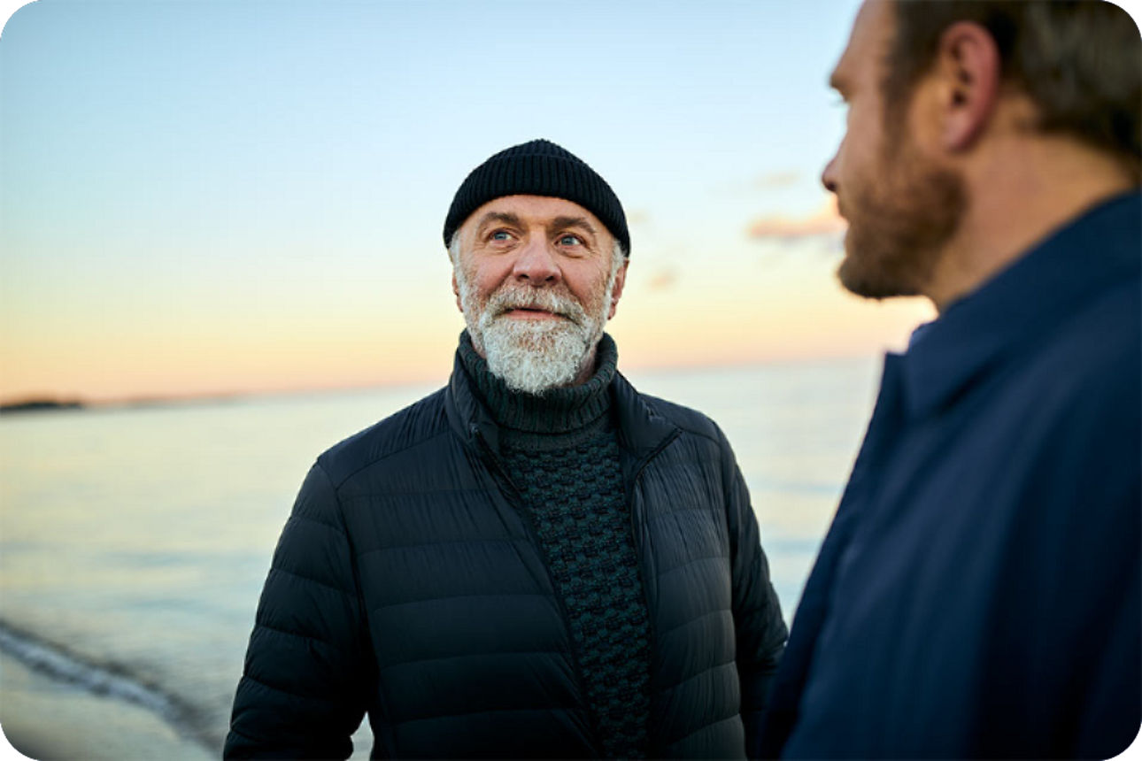 Zwei Männer im Gespräch am Meer
