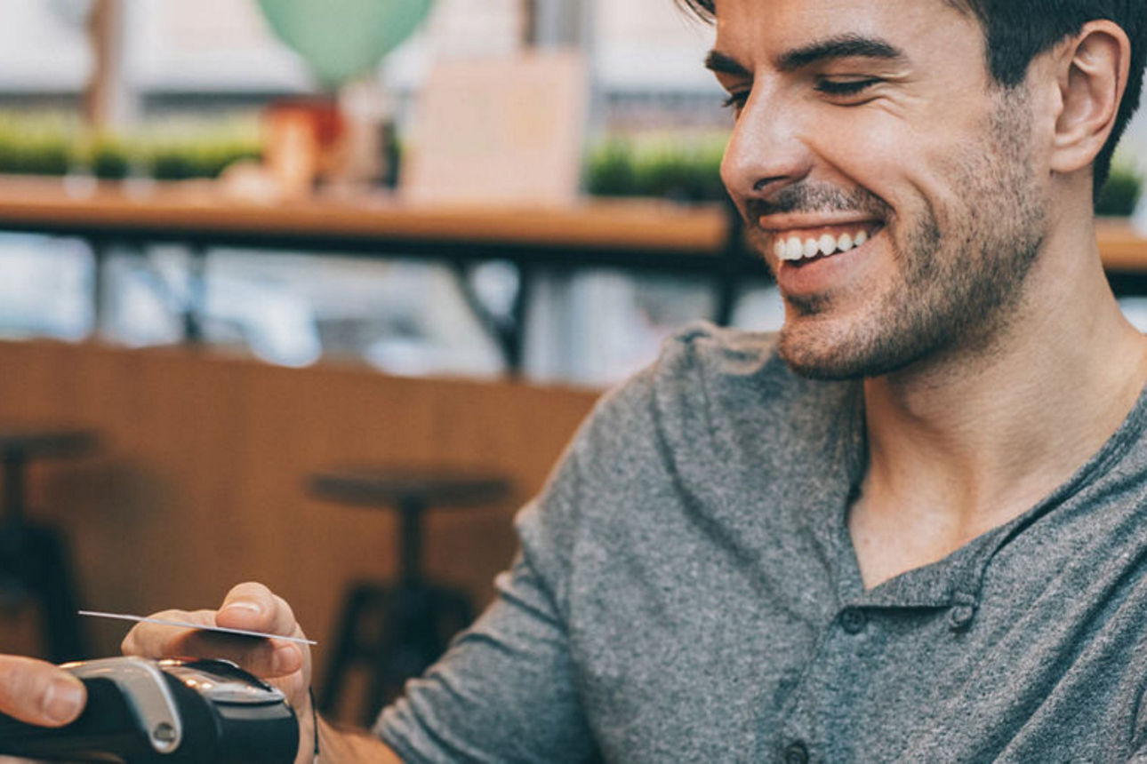 Mann bezahlt per Smartphone