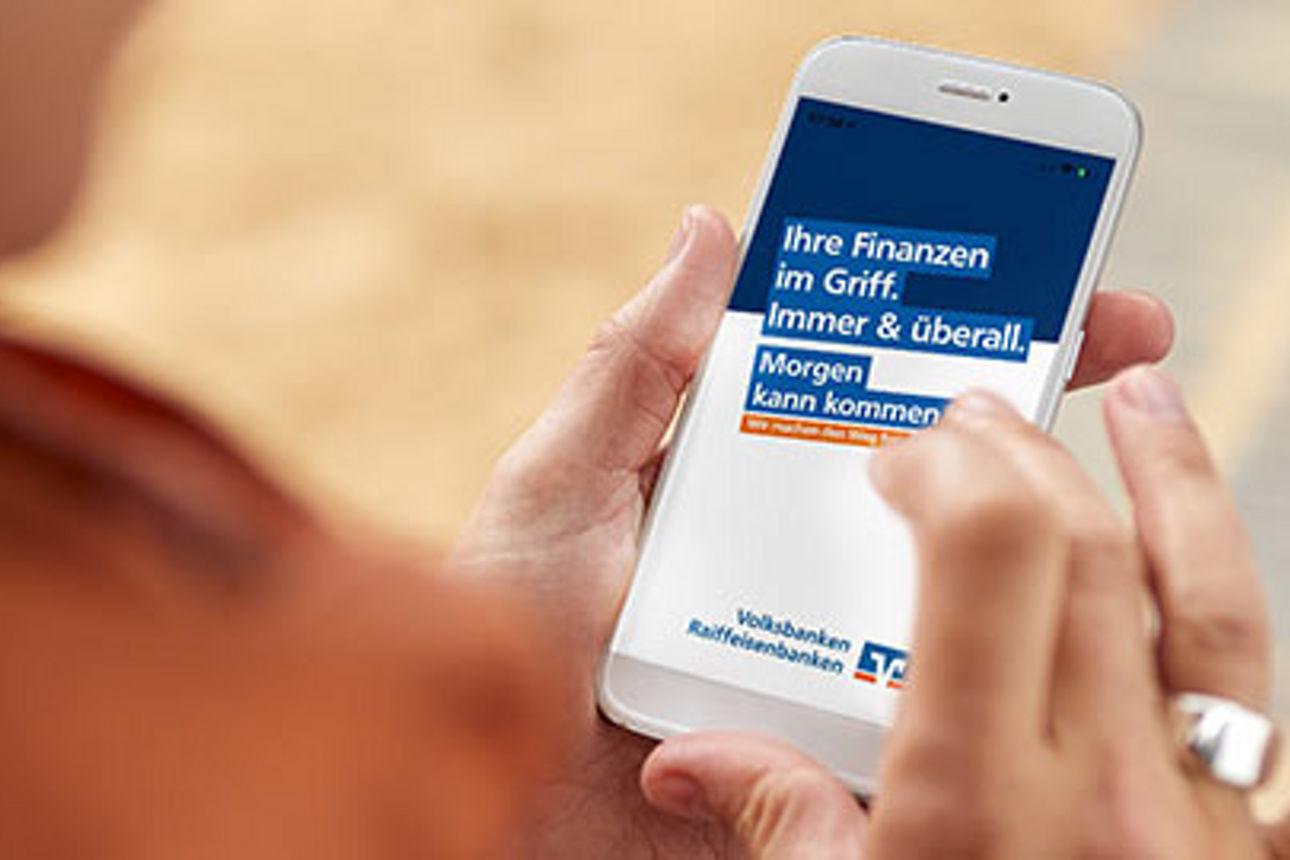 Mensch öffnet auf dem Handy die Seite "Der Morgen kann kommen"