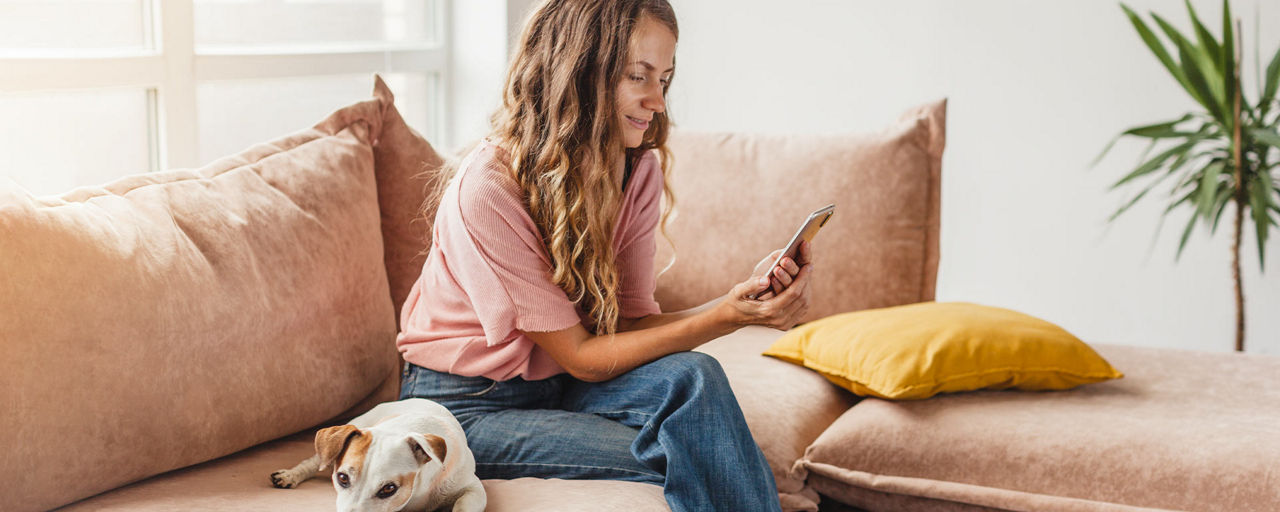 Frau schaut auf die PSD Banking-App in ihrem Smartphone