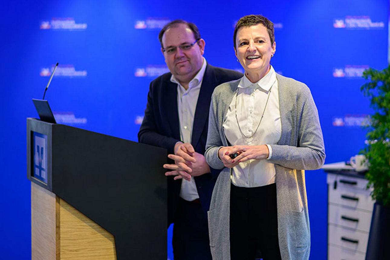 Zwei Personen stehen an einem Rednerpult