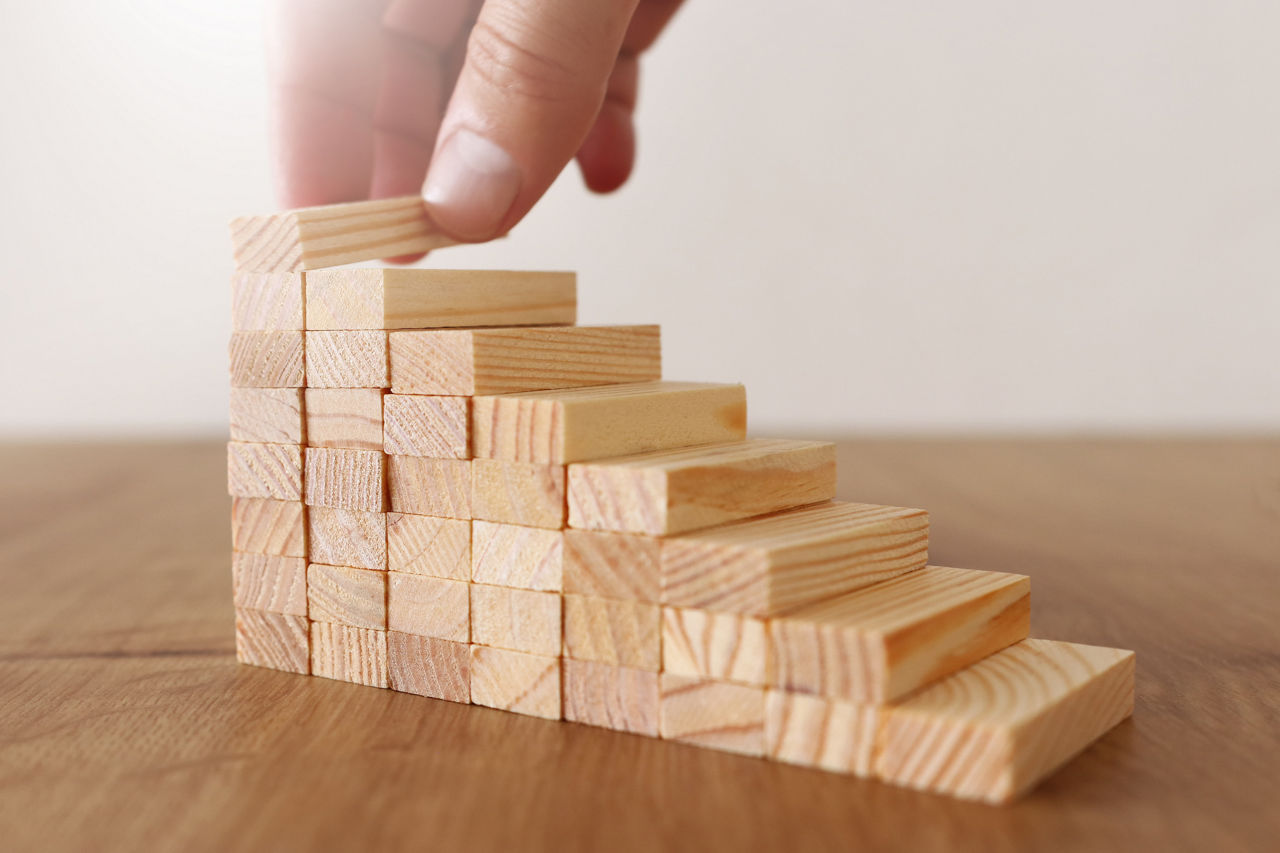 Business image of arranging wood blocks stacking as step stairs. Success and development concept