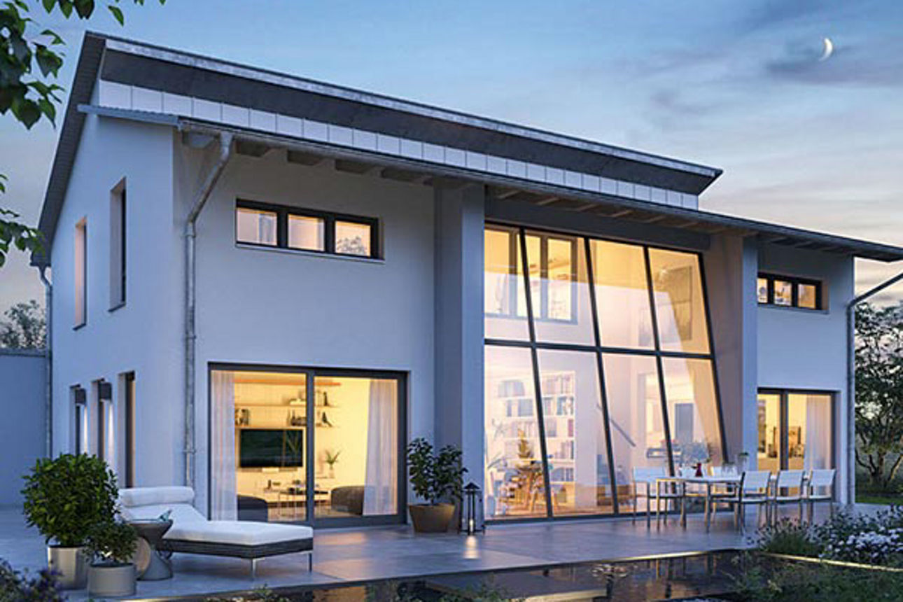 ein großes, modernes Haus, von innen warm beleuchtet.