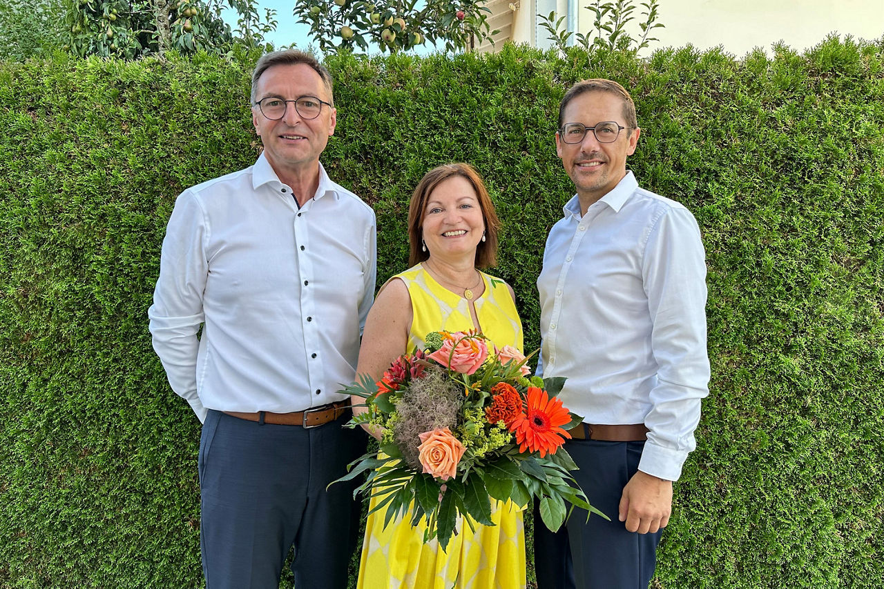 Bettina Fischer  mit einem Blumenstrauß und Anton Ismair und Daniel Attenberger