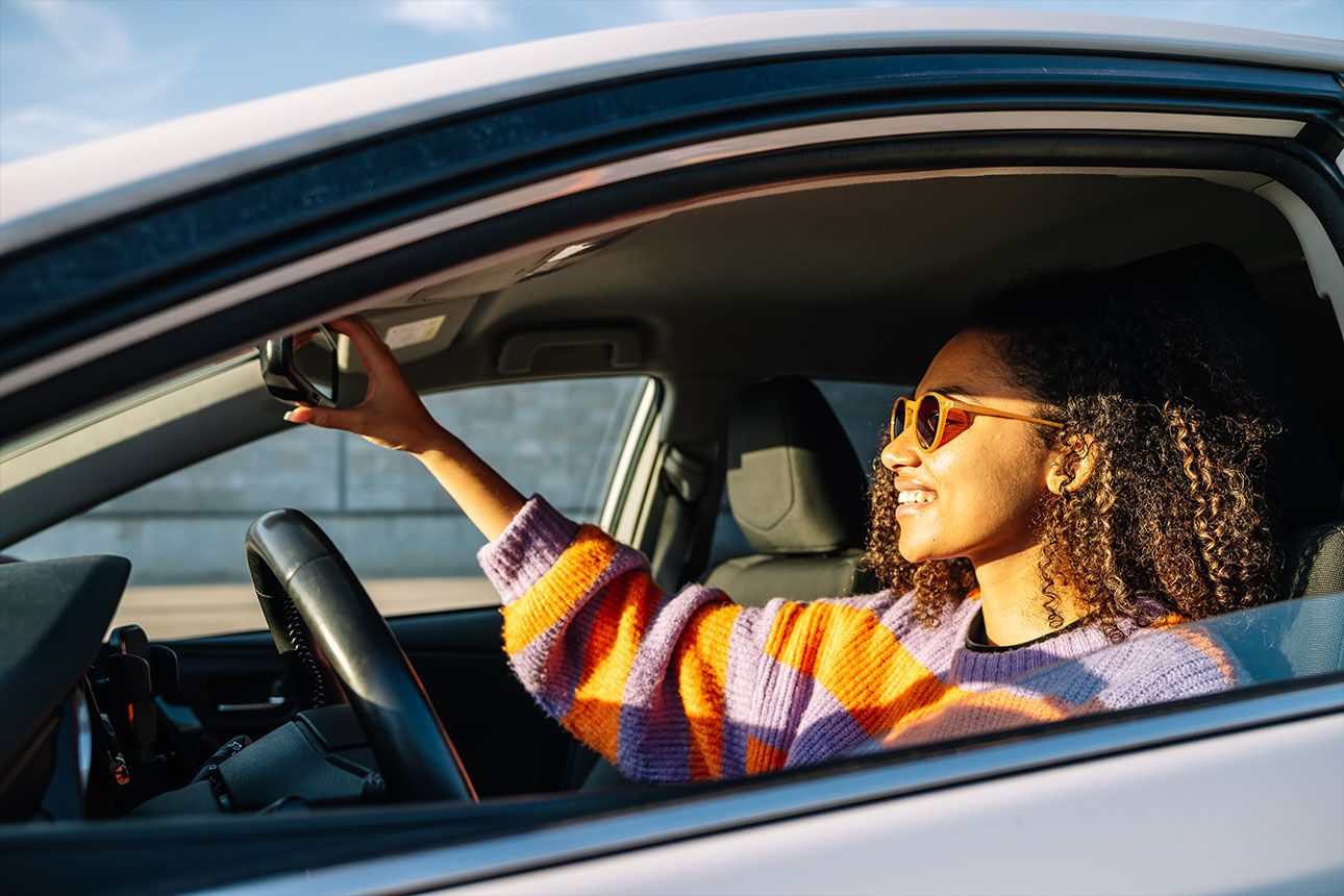 Rear view of senior couple walking outdoors in summer park and embracing, loving happy mature spouses hugging and smiling to each other, cheerful husband and wife enjoying outside walk, copy space