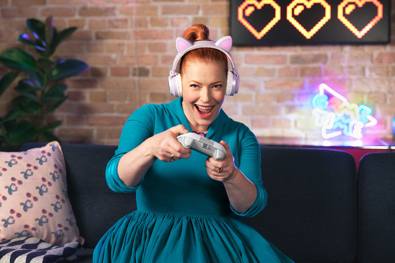 Frau auf dem Sofa mit Controller in der Hand