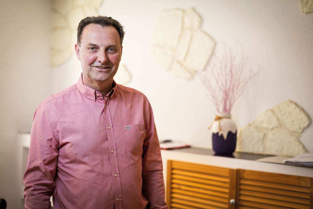 Mario Kolbe steht vor einer Wand