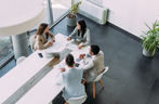 Above view of group of business persons in business meeting. Group of entrepreneurs on meeting in board room. Corporate business team on meeting in the office.