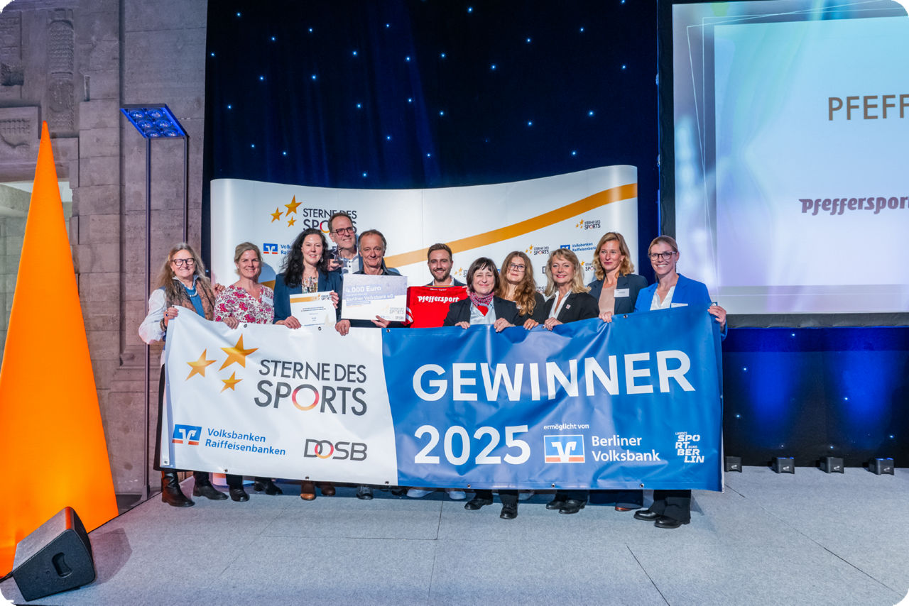 Gewinner*innen halten ein Banner mit Gewinner Sterne des Sports 2025 hoch