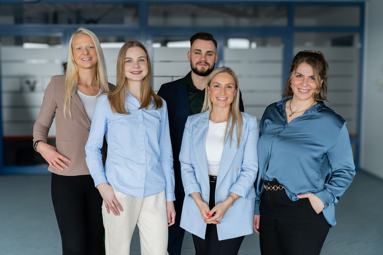 Lächelnde vier junge Frauen und ein Mann