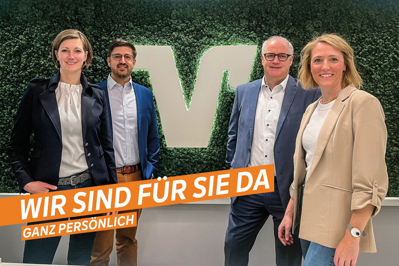 Vier Personen stehen vor einer grünen Wand - Wir sind für Sie da ganz persönlich