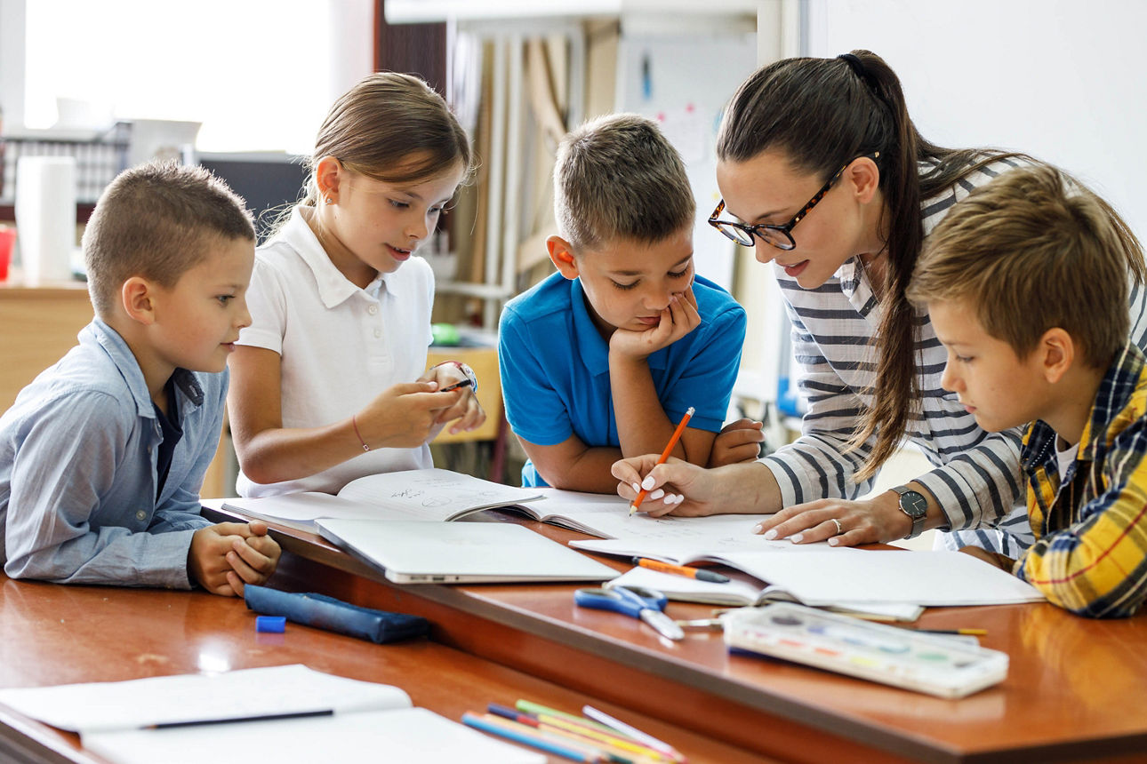 Lehrerin und Schüler korrigieren arbeiten