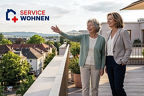 Eine Frau und eine ältere Dame stehen auf einer Terrasse und genießen die Aussicht