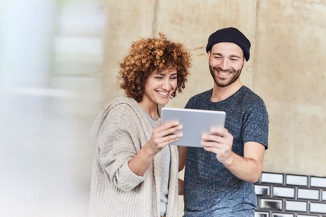 Mann und Frau schauen aufs Ipad
