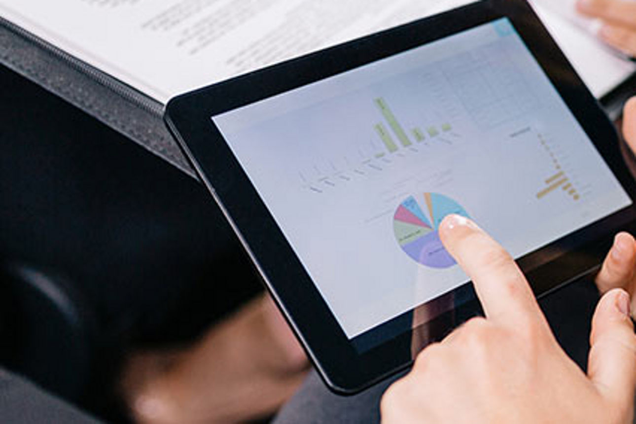 Team überprüft Finanzdaten auf einem Tablet.